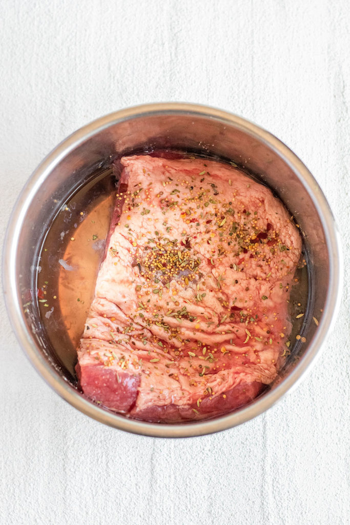 Keto Corned Beef in an instant pot with water and seasoning step 1