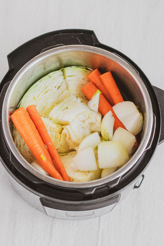 Cabbage carrots and onions chopped in an instant pot in water