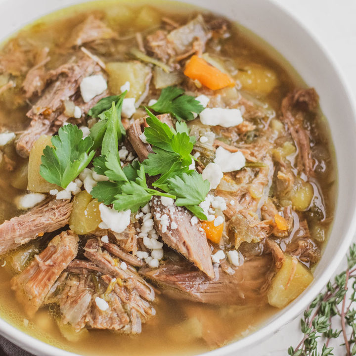 Keto Instant Pot Pot Roast in a white bowl with cilantro on top