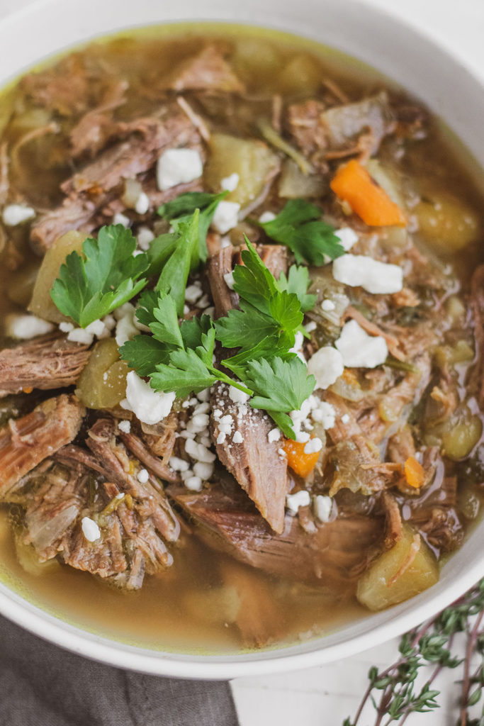 Keto Instant Pot Pot Roast in a white bowl with cilantro on top
