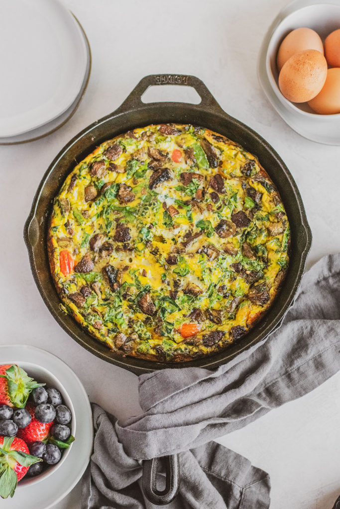 Keto Kale and Mushroom Frittata cooked in a skillet