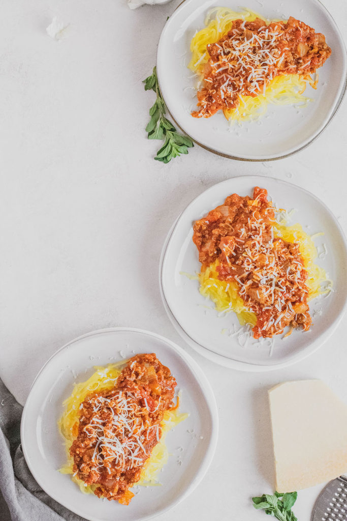 Keto Spaghetti Squash on white plates on a white surface