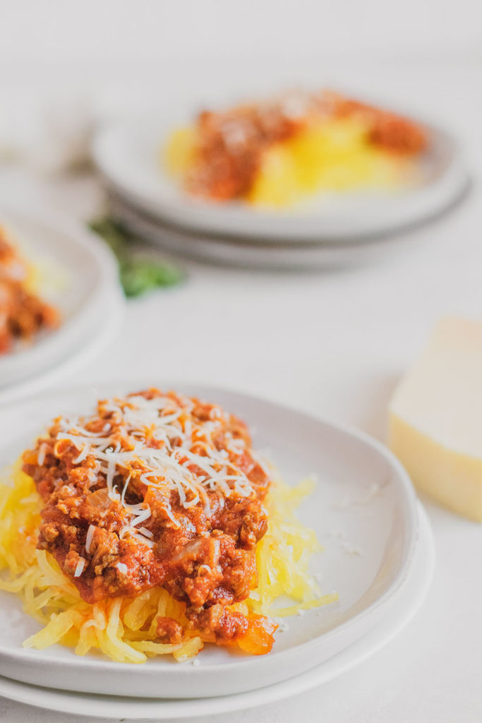 Keto Spaghetti Squash on white plates on a white surface